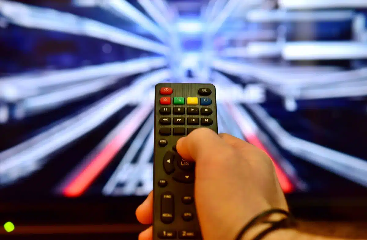 Iptv ultra canada image blog Person using a remote to explore IPTV services on a modern TV – IPTV Canada with IPTV Ultra